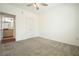 Bedroom boasts neutral carpet, ceiling fan, and closet, leading into bathroom at 10 Perimeter Summit Ne Blvd # 2207, Brookhaven, GA 30319