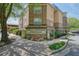 Villa Sonoma Condominiums stone exterior with sign, landscaping, and sidewalk at 10 Perimeter Summit Ne Blvd # 2207, Brookhaven, GA 30319