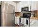 Modern kitchen with stainless steel appliances, including a refrigerator, oven, and microwave at 10 Perimeter Summit Ne Blvd # 2207, Brookhaven, GA 30319