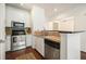 Kitchen featuring stainless steel appliances, stylish backsplash, and an adjacent dining area at 10 Perimeter Summit Ne Blvd # 2207, Brookhaven, GA 30319