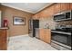 A well-appointed kitchenette features tile backsplash, stainless steel appliances, and cabinetry at 10 Perimeter Summit Ne Blvd # 2207, Brookhaven, GA 30319