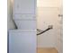 Laundry room with white washer and dryer, storage shelves, and tile flooring at 10 Perimeter Summit Ne Blvd # 2207, Brookhaven, GA 30319