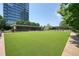 Well-manicured lawn with community amenities and a modern building in the background at 10 Perimeter Summit Ne Blvd # 2207, Brookhaven, GA 30319