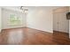 Bright living room featuring hardwood floors, a ceiling fan, and a large window for natural light at 10 Perimeter Summit Ne Blvd # 2207, Brookhaven, GA 30319