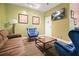 Comfortable lounge area with brown sofa, blue chairs, and a coffee table for relaxation at 10 Perimeter Summit Ne Blvd # 2207, Brookhaven, GA 30319