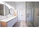 Modern bathroom with a double sink vanity, large mirrors, and glass-enclosed shower at 1155 Custer Se Ave # 201, Atlanta, GA 30316