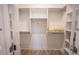 Bright, walk-in closet with custom shelving, hanging rods, and hardwood floors at 1155 Custer Se Ave # 201, Atlanta, GA 30316