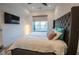 Spacious bedroom with large bed, headboard, big window, and a mounted flatscreen TV at 1155 Custer Se Ave # 201, Atlanta, GA 30316
