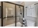 Modern bathroom with glass-enclosed shower, neutral tile, and sleek fixtures at 1304 Brookhavenrun Cir, Duluth, GA 30097