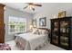Charming bedroom with a cozy bed, decorative accents, and plenty of natural light from the window at 1304 Brookhavenrun Cir, Duluth, GA 30097