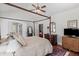 Comfortable bedroom featuring a large bed, hardwood floors, and neutral decor at 1304 Brookhavenrun Cir, Duluth, GA 30097