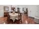A dining room with a chandelier has hardwood floors and a view of the front door at 1304 Brookhavenrun Cir, Duluth, GA 30097