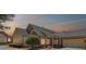 A lovely brick home at dusk features a manicured yard and a spacious driveway with a two-car garage at 1304 Brookhavenrun Cir, Duluth, GA 30097