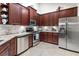 Updated kitchen with stainless steel appliances, dark wood cabinets, and plenty of storage at 1304 Brookhavenrun Cir, Duluth, GA 30097