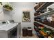Bright laundry room featuring a washer, dryer, shelving, and ample storage space at 1304 Brookhavenrun Cir, Duluth, GA 30097