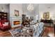 Living room with fireplace, hardwood floors, and dining room with chandelier at 1304 Brookhavenrun Cir, Duluth, GA 30097