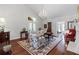 Light-filled living room with hardwood floors, floral pattern seating, and high ceilings at 1304 Brookhavenrun Cir, Duluth, GA 30097
