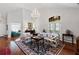 Bright living room with hardwood floors, elegant chandelier, and comfortable seating arrangement at 1304 Brookhavenrun Cir, Duluth, GA 30097