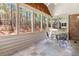Inviting sunroom with tile floors, a table with chairs, and scenic views of the surrounding greenery at 1304 Brookhavenrun Cir, Duluth, GA 30097