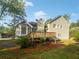 Exterior back view of a home with a large wooden deck and treed yard at 1307 Chandler Nw Ct, Acworth, GA 30102