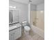 Neutral bathroom featuring a tiled floor, granite vanity top, and shower-tub combo at 1307 Chandler Nw Ct, Acworth, GA 30102