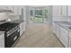 Bright kitchen showcasing white cabinets, granite countertops, stainless steel appliances, and breakfast nook at 1307 Chandler Nw Ct, Acworth, GA 30102