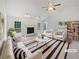 Bright living room featuring fireplace, ceiling fan, and large windows at 1307 Chandler Nw Ct, Acworth, GA 30102