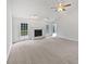 Bright living room featuring fireplace, ceiling fan, and large windows at 1307 Chandler Nw Ct, Acworth, GA 30102