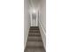 Hallway staircase featuring carpeted steps, leading to upper level of the house at 1307 Chandler Nw Ct, Acworth, GA 30102