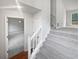 Carpeted staircase with white railing leading to the upper level, open concept living at 1307 Chandler Nw Ct, Acworth, GA 30102