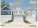 Charming townhome showcasing a well-manicured lawn, multi-car garage, and diverse exterior paint scheme at 2688 Ne Almand Ln, Conyers, GA 30013