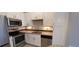 This modern kitchen has stainless appliances, white cabinets, and attractive backsplash at 400 17Th St # 1114, Atlanta, GA 30318