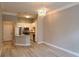 Open floor plan showcasing kitchen with modern lighting, stainless appliances, and breakfast bar at 400 17Th St # 1114, Atlanta, GA 30318