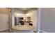 Well-lit kitchen boasts white cabinets, stainless steel appliances, and a granite-topped island at 400 17Th St # 1114, Atlanta, GA 30318