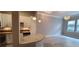 Living room view featuring white cabinets, stainless appliances, mosaic backsplash, & natural light at 400 17Th St # 1114, Atlanta, GA 30318
