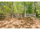 Backyard featuring a hammock strung between trees, with a wooded backdrop at 1010 Forest Creek Dr, Canton, GA 30115