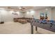 Spacious finished basement featuring a large sectional, foosball table, and an adjacent game room at 1010 Forest Creek Dr, Canton, GA 30115