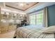 Comfortable bedroom with tray ceilings, large window, and custom storage cabinets at 1010 Forest Creek Dr, Canton, GA 30115