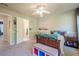 Bright bedroom features neutral paint, ceiling fan, ensuite access and neutral carpet at 1010 Forest Creek Dr, Canton, GA 30115