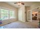 Spacious bedroom with neutral tones, carpet and view of another room through french doors at 1010 Forest Creek Dr, Canton, GA 30115