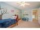 Colorful bedroom features a ceiling fan, neutral carpet and bright paint at 1010 Forest Creek Dr, Canton, GA 30115