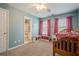 Adorable bedroom features a ceiling fan, pink curtains, ensuite access and neutral carpet at 1010 Forest Creek Dr, Canton, GA 30115