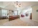 Spacious bedroom featuring vaulted ceilings, a ceiling fan, and neutral carpeting at 1010 Forest Creek Dr, Canton, GA 30115