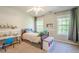 Bright bedroom with neutral paint, ceiling fan, built in desk and neutral carpet at 1010 Forest Creek Dr, Canton, GA 30115