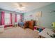 Adorable bedroom features a ceiling fan, pink curtains, neutral carpet and bright paint at 1010 Forest Creek Dr, Canton, GA 30115