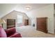 Attic bonus room with built in bookshelves and a lovely accent chair at 1010 Forest Creek Dr, Canton, GA 30115