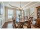 Inviting dining room with a large table, elegant chandelier, and decorative wainscoting at 1010 Forest Creek Dr, Canton, GA 30115