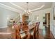 Well-lit dining room with a beautiful chandelier and decorative wainscoting detail at 1010 Forest Creek Dr, Canton, GA 30115