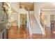 Bright foyer featuring hardwood floors, staircase with decorative wrought iron, and open floor plan at 1010 Forest Creek Dr, Canton, GA 30115