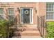 Inviting front entrance with decorative wreath, sconces, and iron railings, leading to a welcoming front door at 1010 Forest Creek Dr, Canton, GA 30115